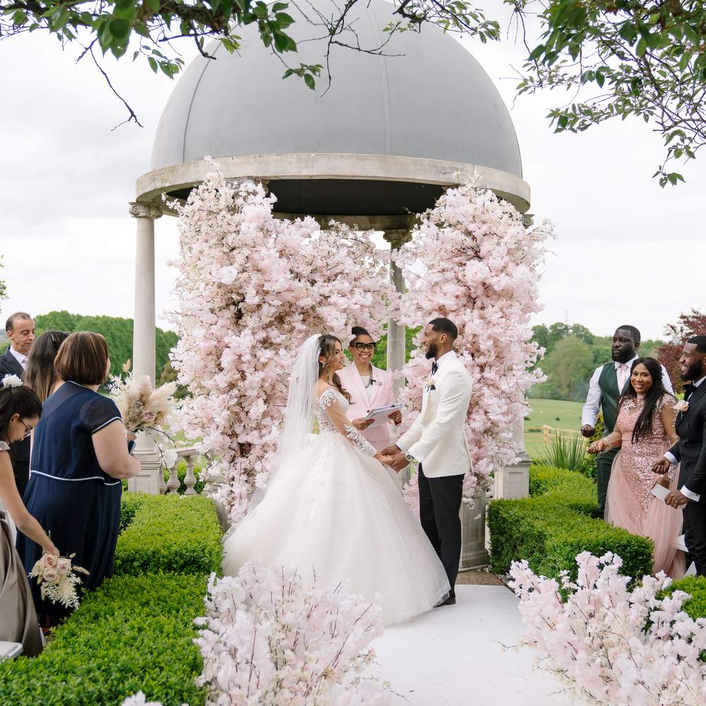 Amazing Nigerian outdoor civil Ceremony featuring pink blossom trees at Russets's Dome.