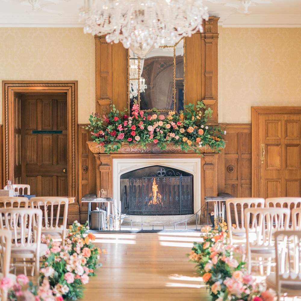 Indoor civil ceremony setup in Russets's Great Hall. This space can seat up to 140 guests and has a number of original Jacobean features, including a working fire place, crystal chandeliers and beautiful wood panelling. Ideal for cosy Winter weddings.