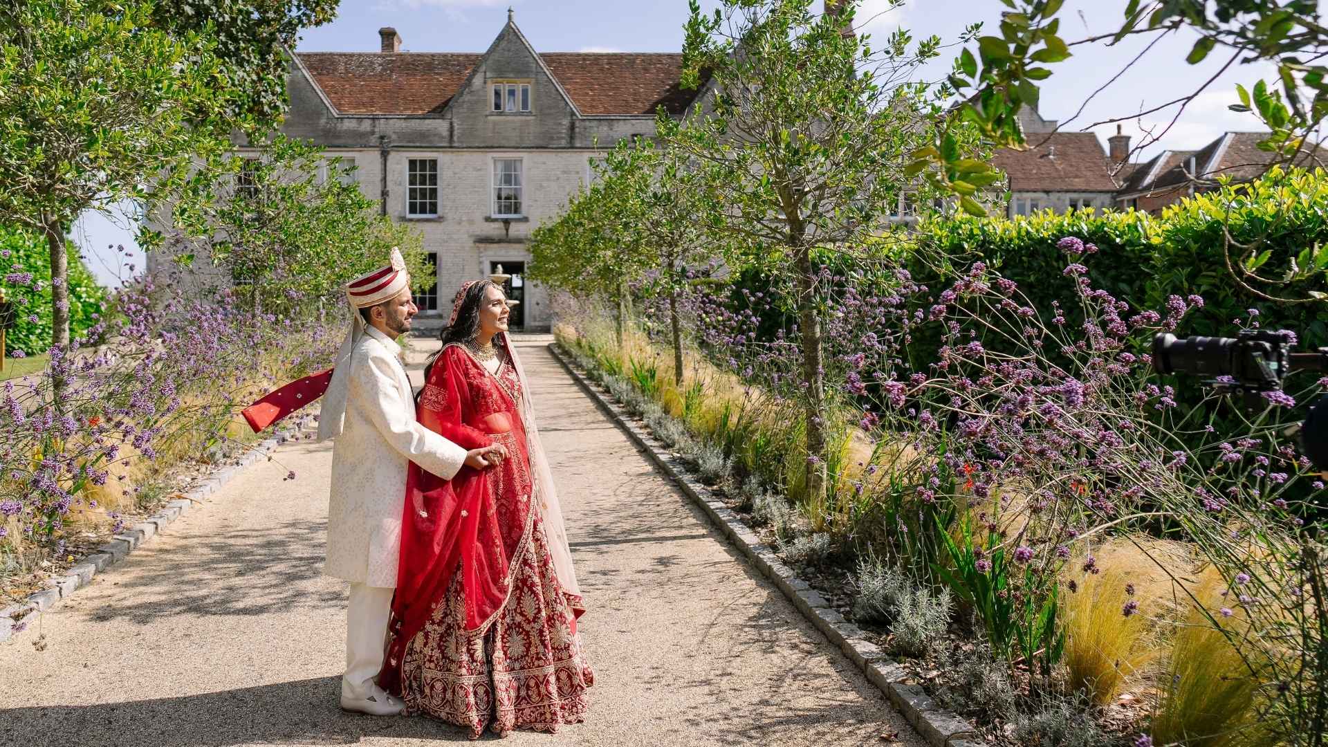 Hindu Bride & Groom posing at the front of Russets's well manicured entrance