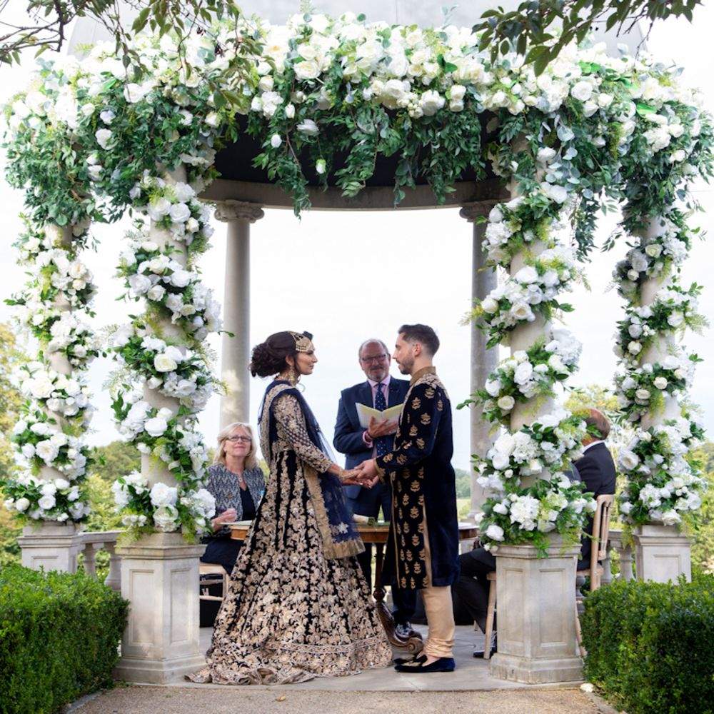 An South Asian Bride & Groom exchange their wedding vows outdoors at Russets