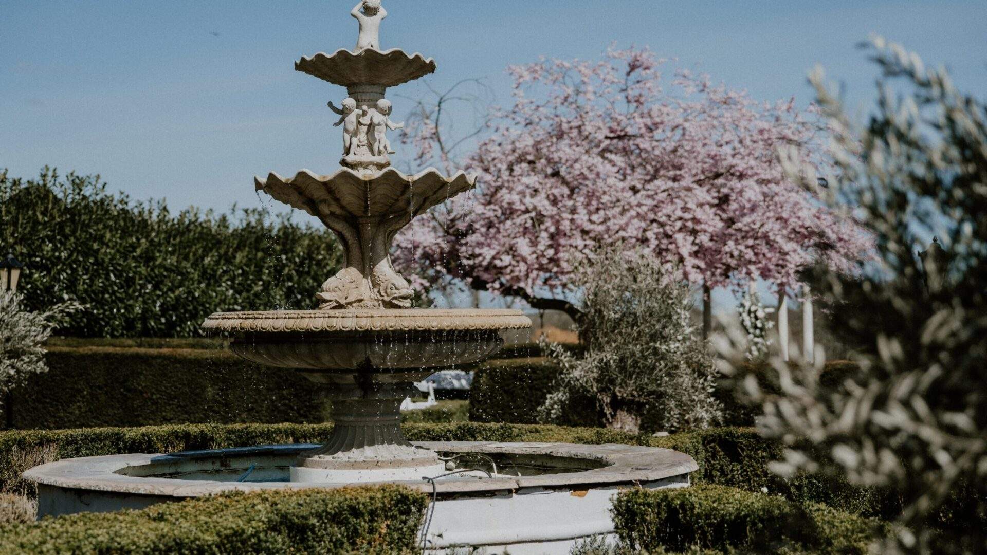 Russets, a country house wedding venue in Hampshire, has classical stone water fountains - beautiful photo backdrops.
