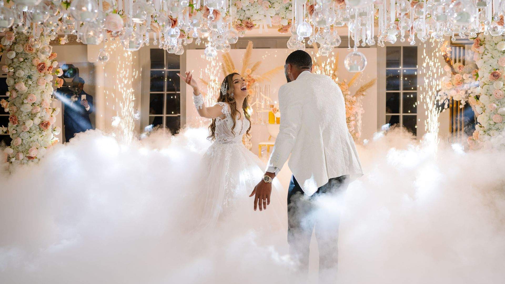 A beautiful Bride & Groom enjoying their first dance with a smoke machine in the Grand Ballroom at Russets - an exclusive use wedding venue on the Surrey / Hampshire border.