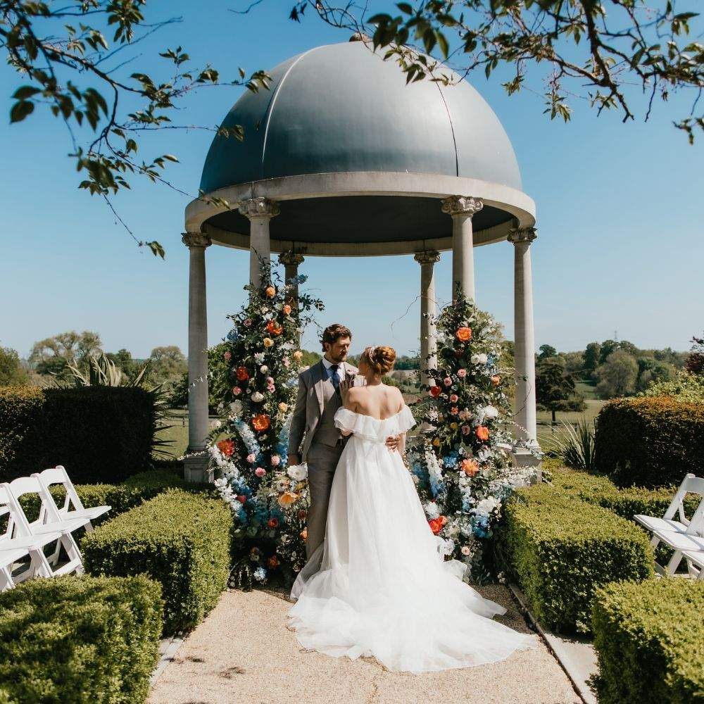 A stunning Bride & Groom exchange vows at Russets's iconic outdoor ceremony location in Hampshire - the Dome