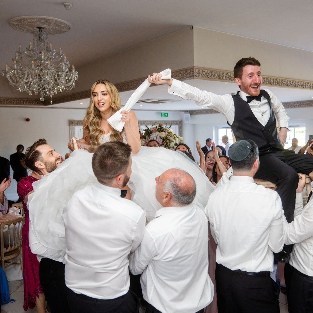 The Jewish chair lift dance during the Hora of a Jewish wedding at Russets in Surrey.